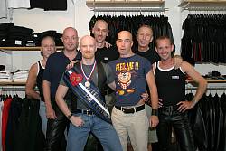 Photo of John with the staff of RoB leather shop, August 2003